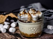 Dessert sampler on a white plate with pie slices, whipped cream, and a scoop of vanilla ice cream