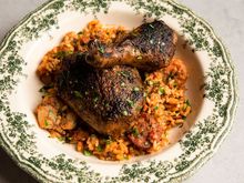 Bowl of grilled fish with green beans and rice on a wooden table