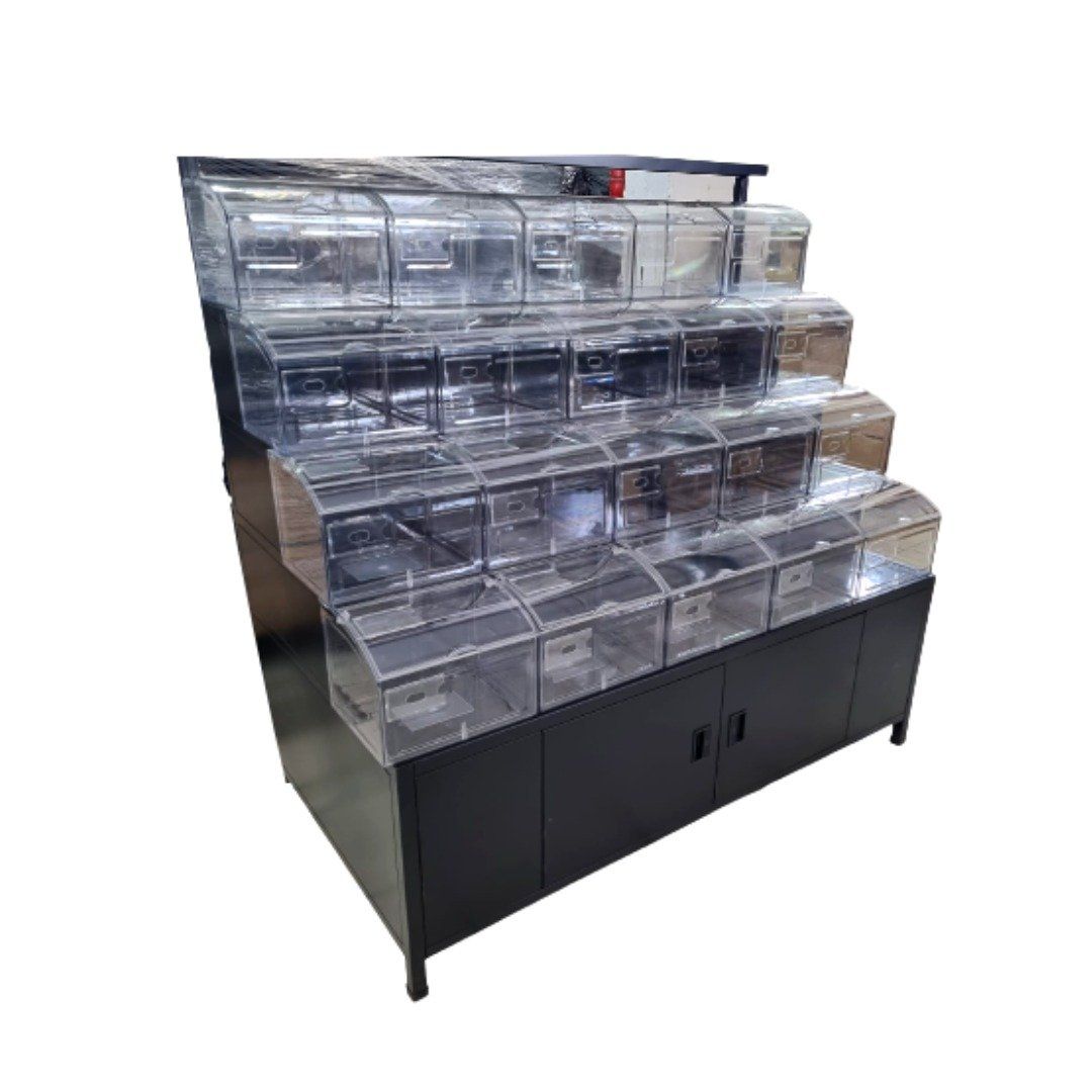 Clear plastic display bins on a black multi-tier retail stand with cabinet base