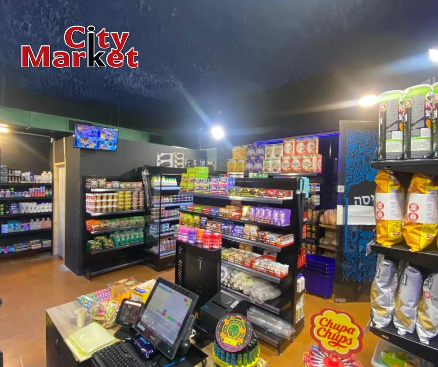 City Market convenience store interior with shelves of snacks, drinks, and checkout counter