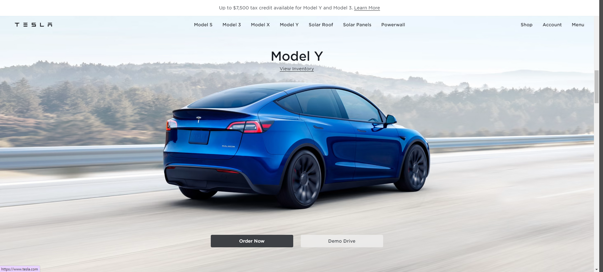 Blue Tesla Model Y driving on a road, shown on a minimalist car website homepage