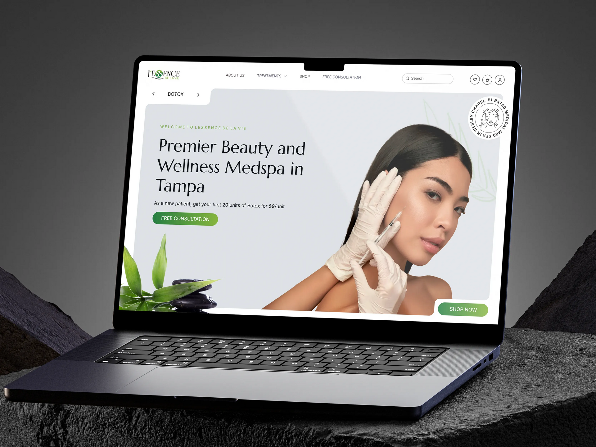 Laptop displaying a beauty and wellness website with a woman’s face and green accents