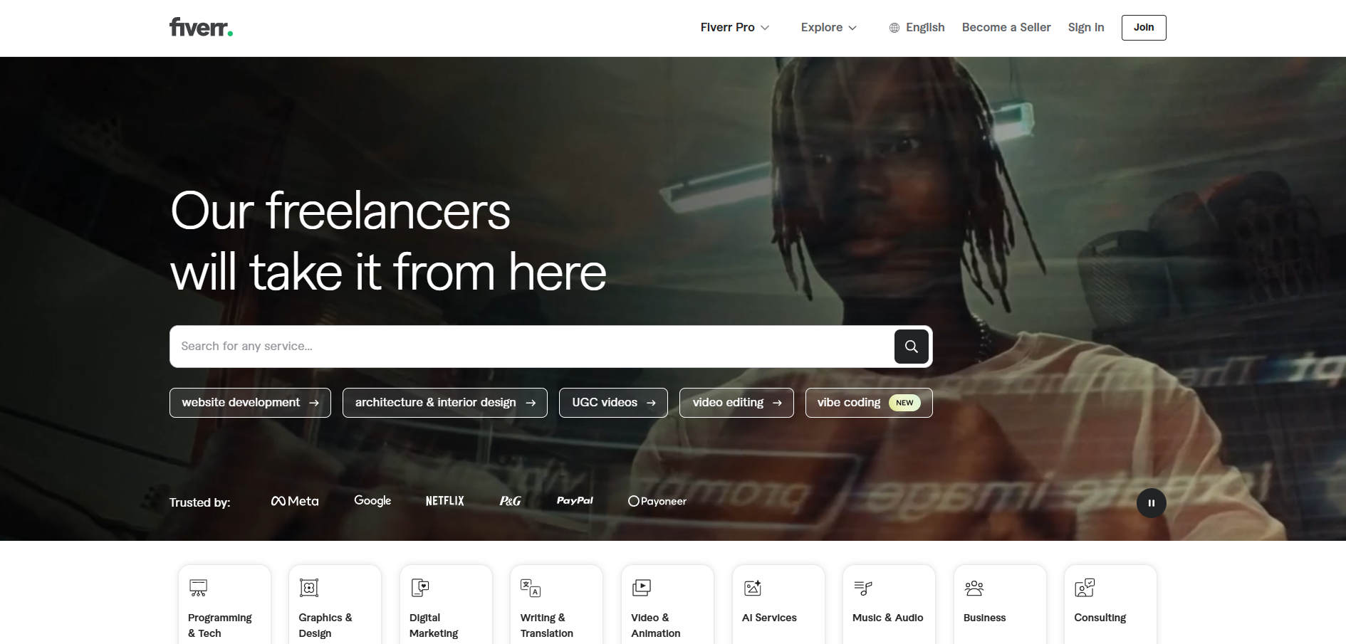 Freelancer marketplace homepage with search bar over a dark hero image and white navigation links