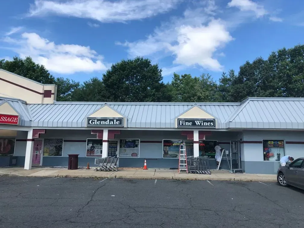 A glendale store with a car parked in front of it