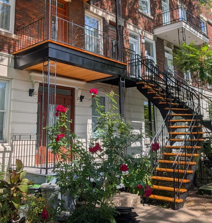 Une grande maison en pierre avec des escaliers qui y mènent.