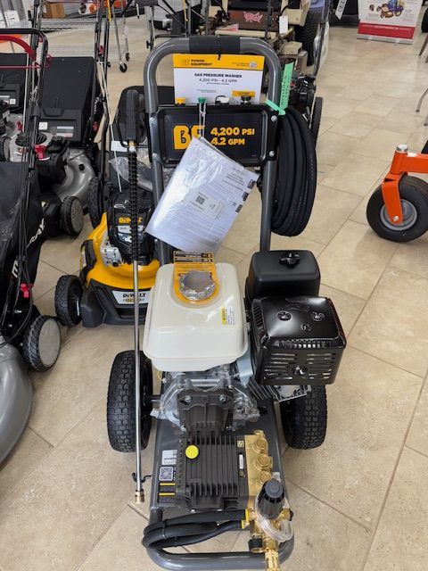 A black and yellow pressure washer displayed in a store.