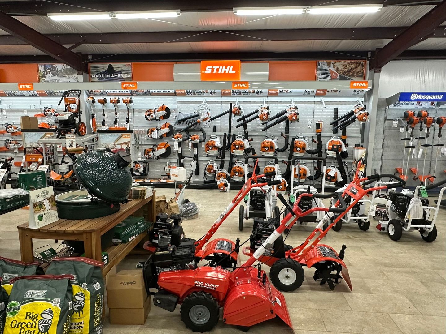 Inside a hardware store, display of Stihl and Husqvarna power tools.