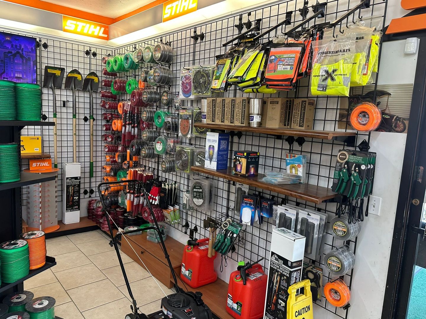 Inside a Stihl store, tools and accessories are displayed on racks.
