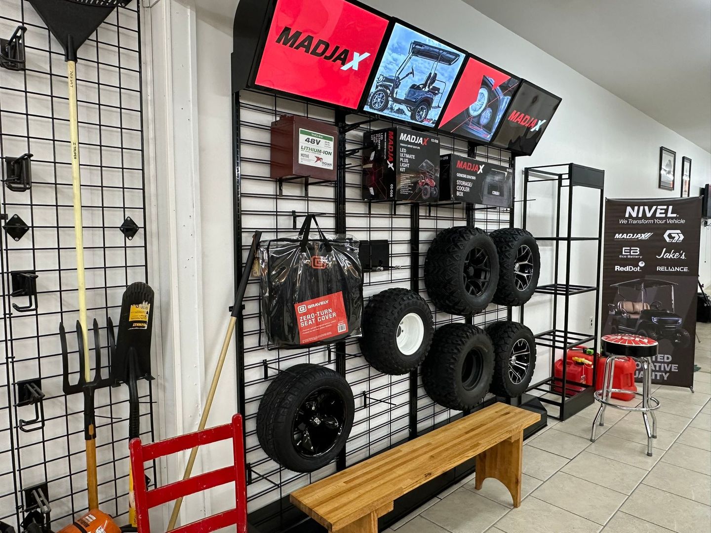 Retail store interior with display of tires, accessories, and signage.
