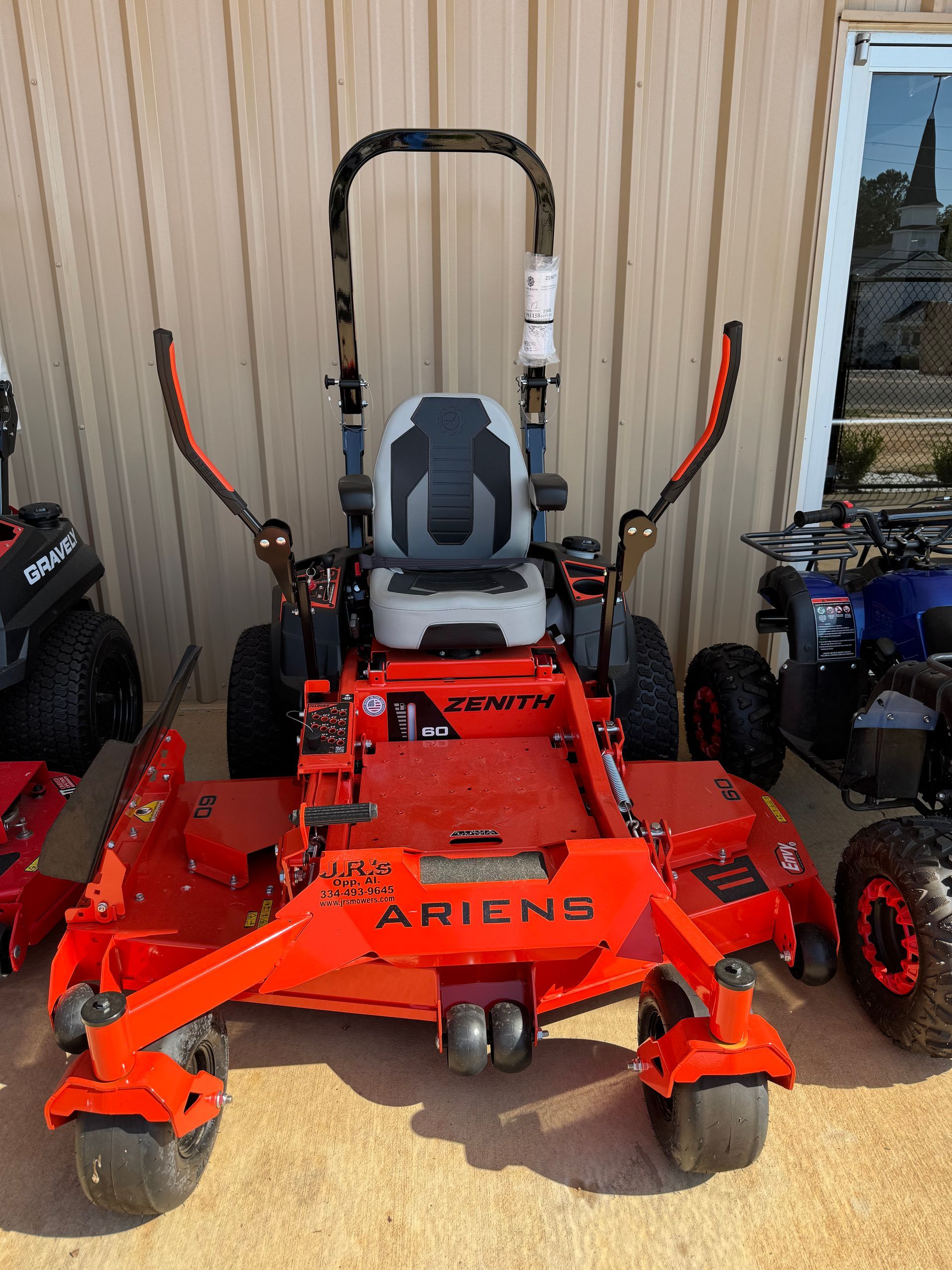 Orange Ariens Zenith zero-turn lawn mower on display, angled toward the viewer.