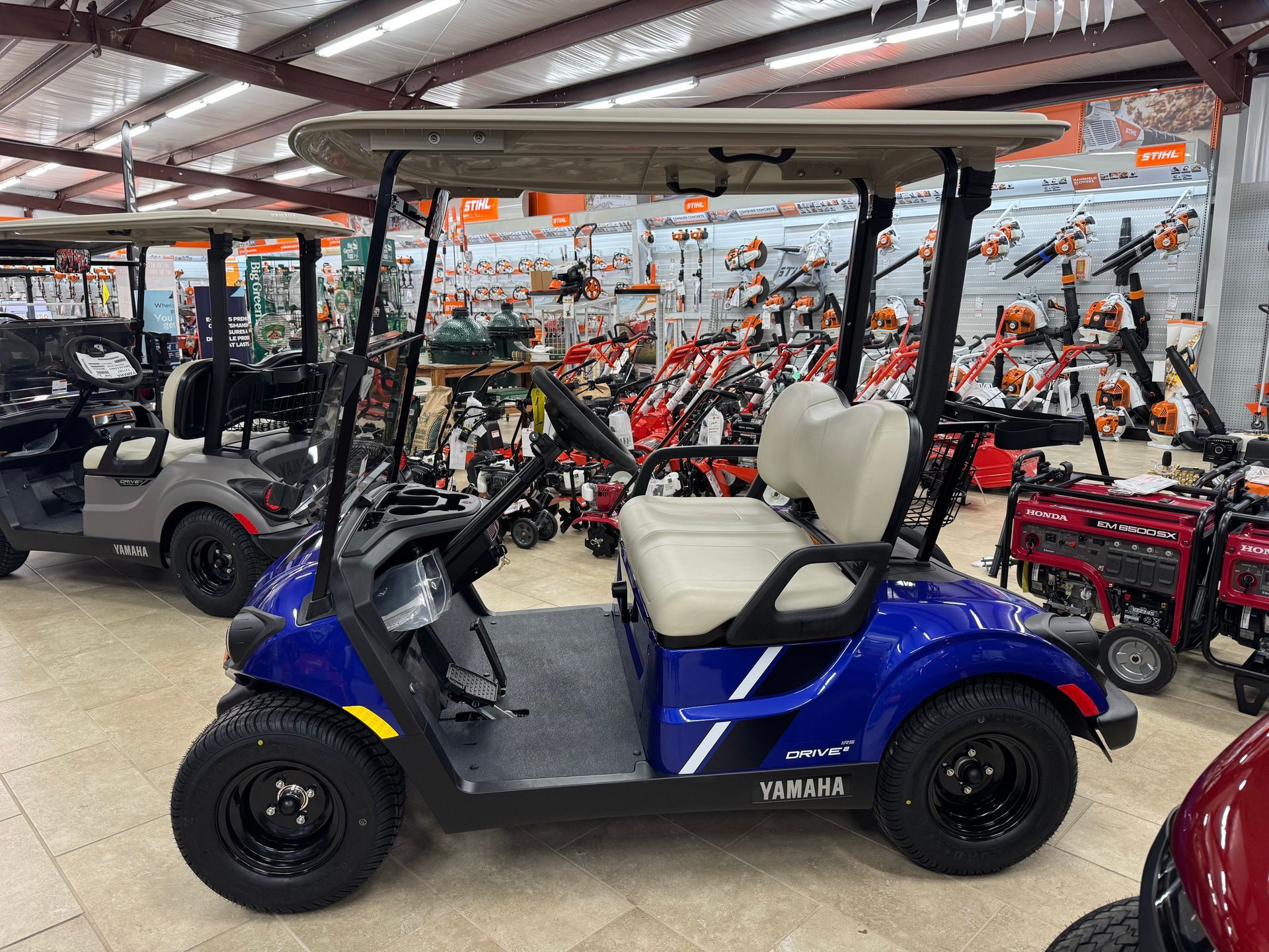 Blue Yamaha golf cart parked inside a store.
