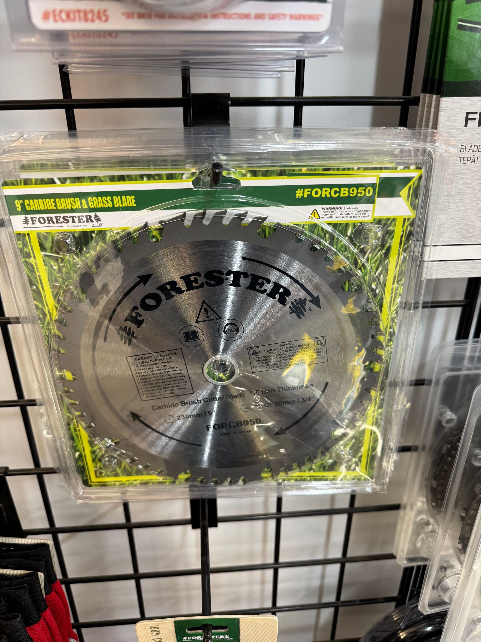 Forester circular saw blade in plastic packaging, displayed on a wire rack.