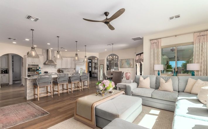Open-plan living area with kitchen, dining, and living room in light blue and white tones.