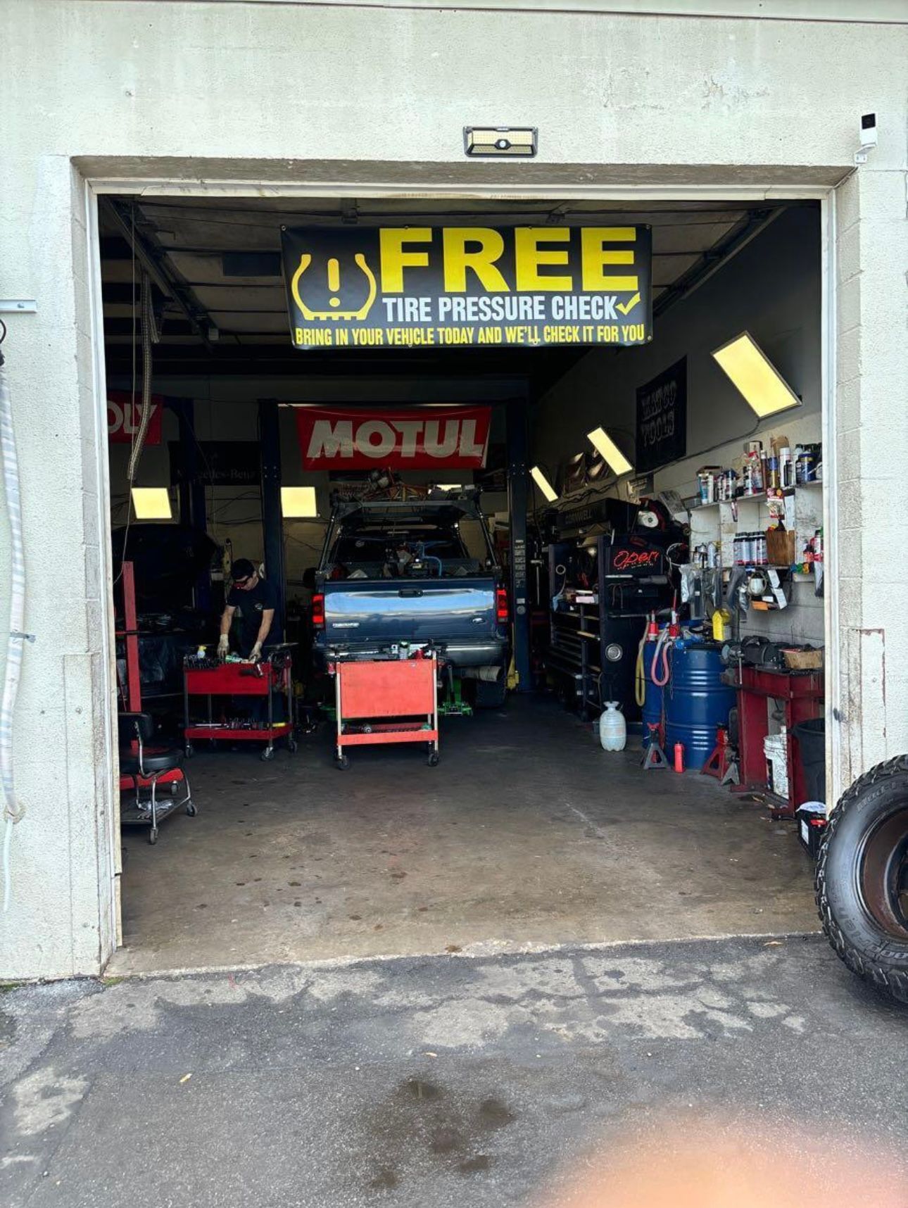 Auto repair garage entrance with a car inside and a large