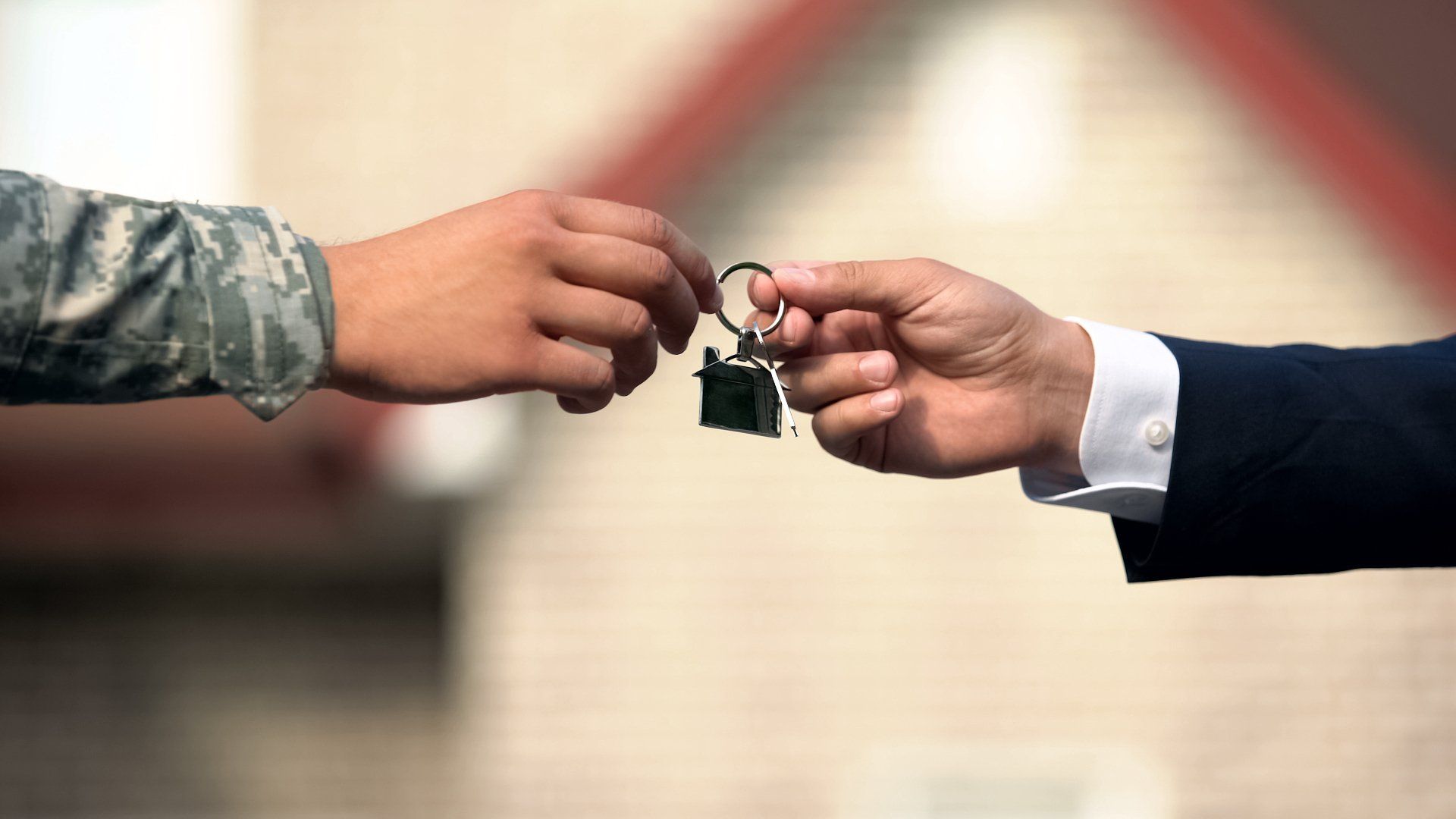 Photo of business man handing keys to military member