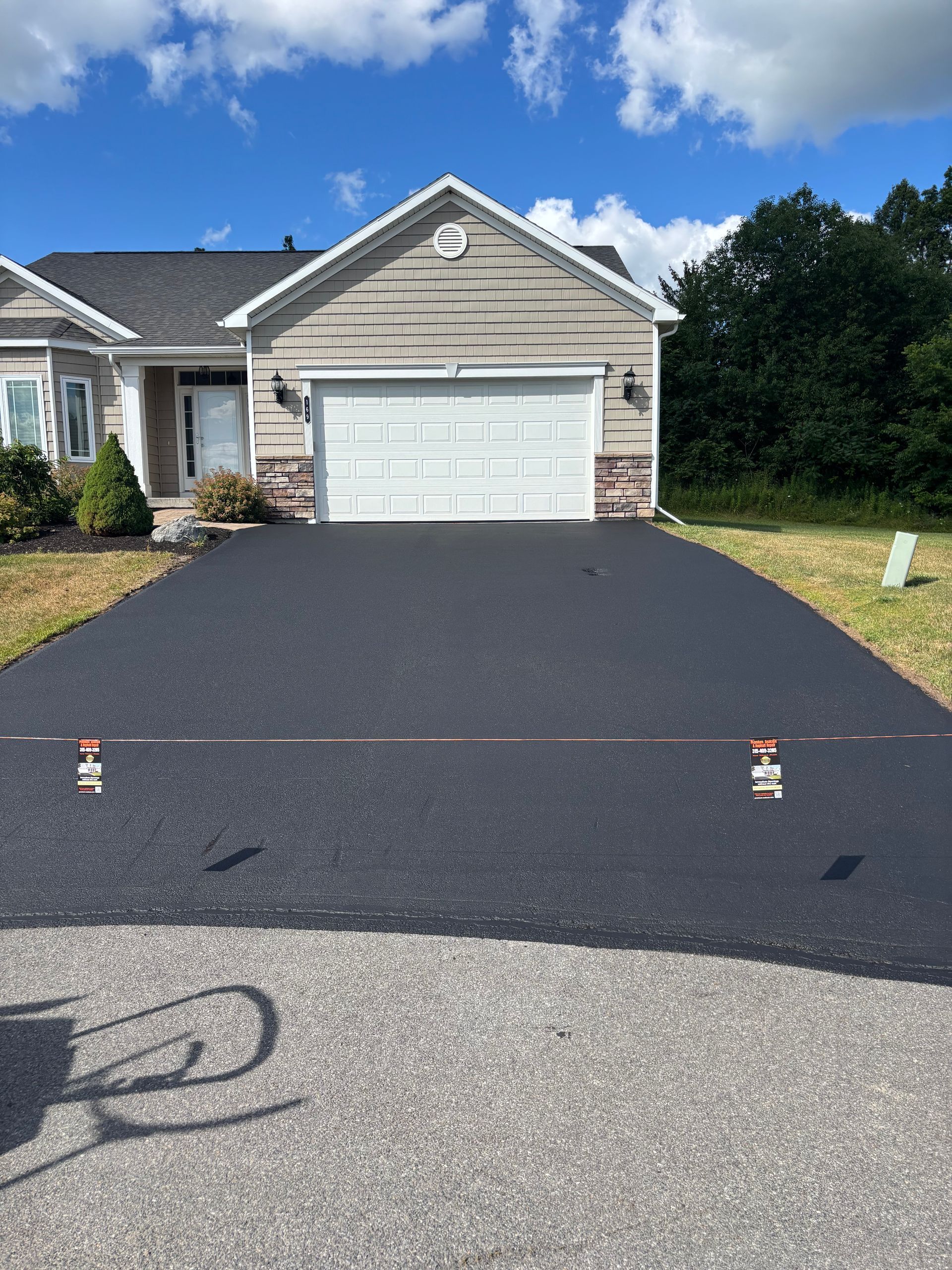 A house with a large driveway in front of it.