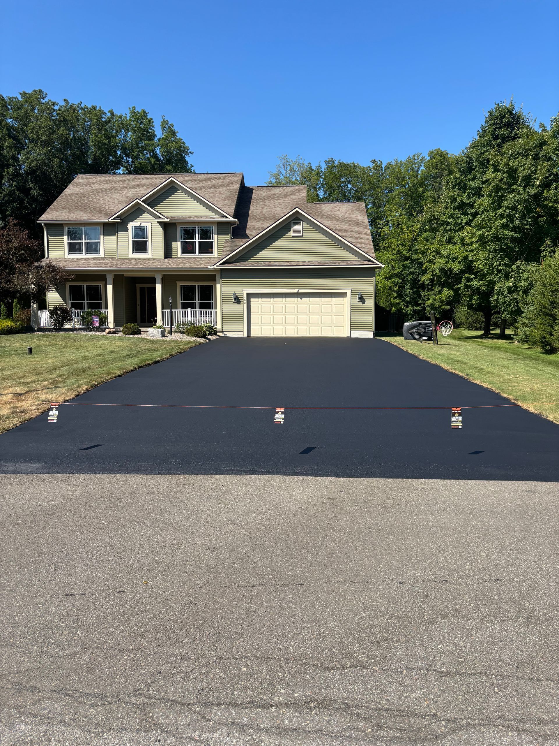 A large house with a large driveway in front of it