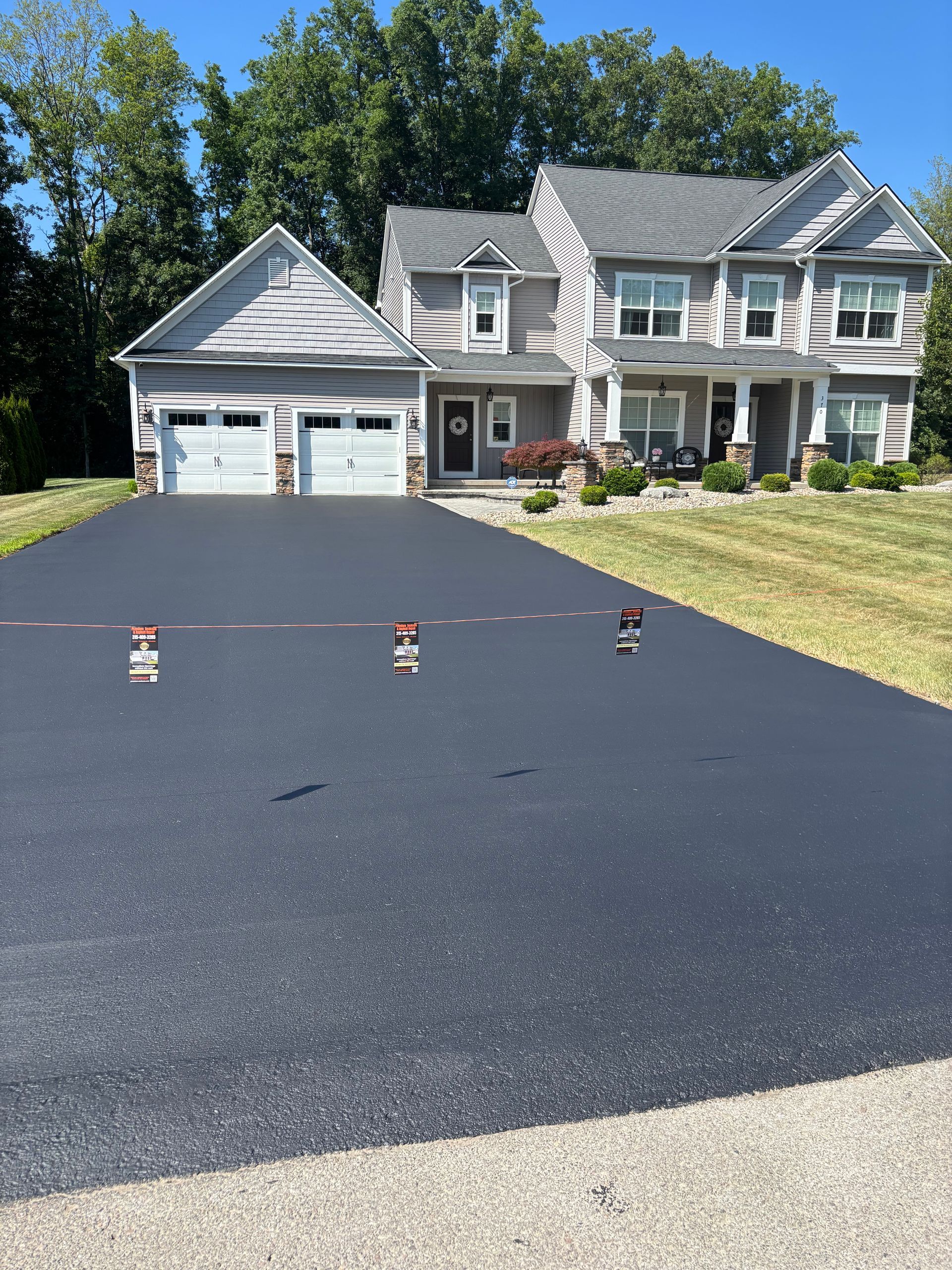 A large house with a large driveway in front of it