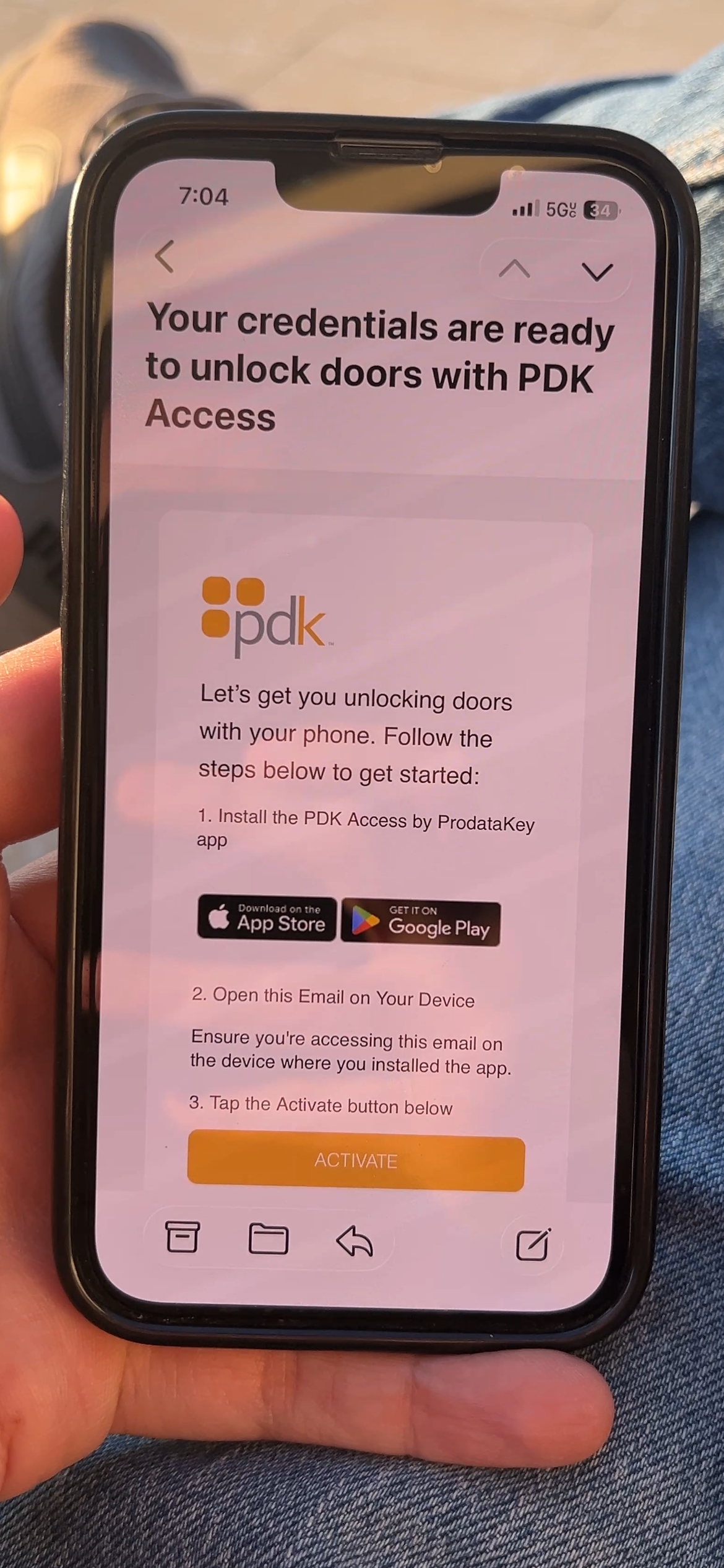 A phone screen showing the pdk.io cloud-based access control login page with a yellow cloud logo.