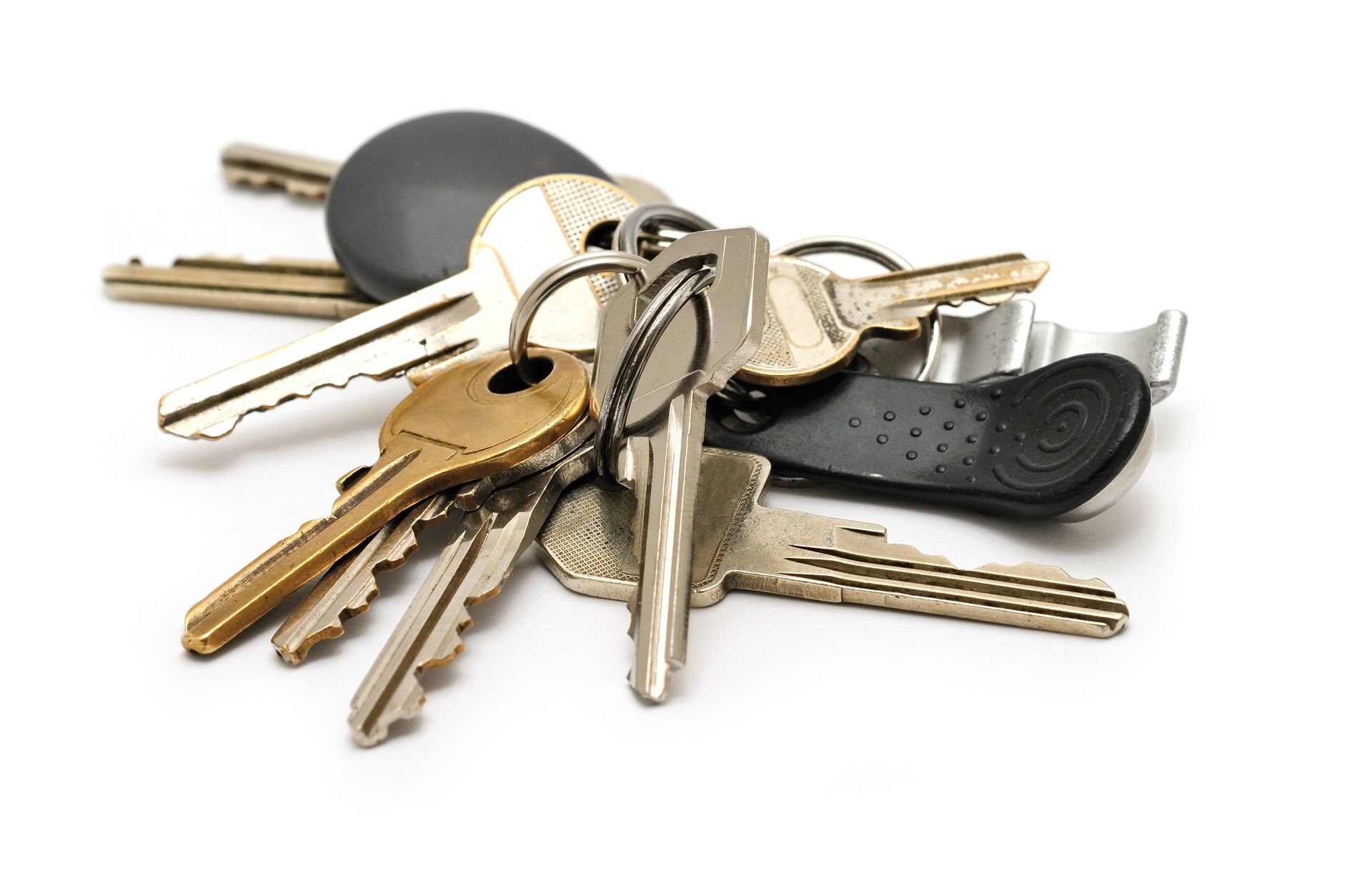 A bunch of keys are stacked on top of each other on a white background
