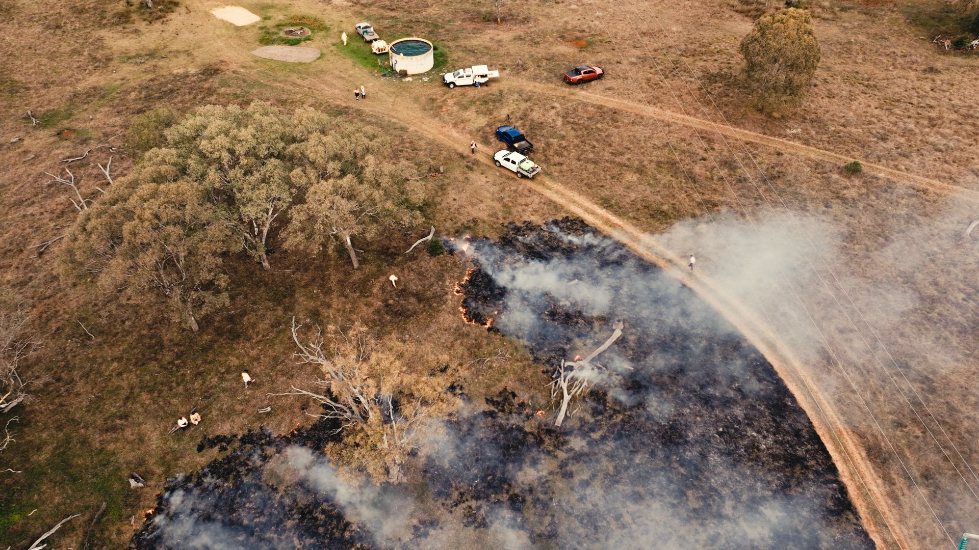 aerial shot of grazing country with active cool burn