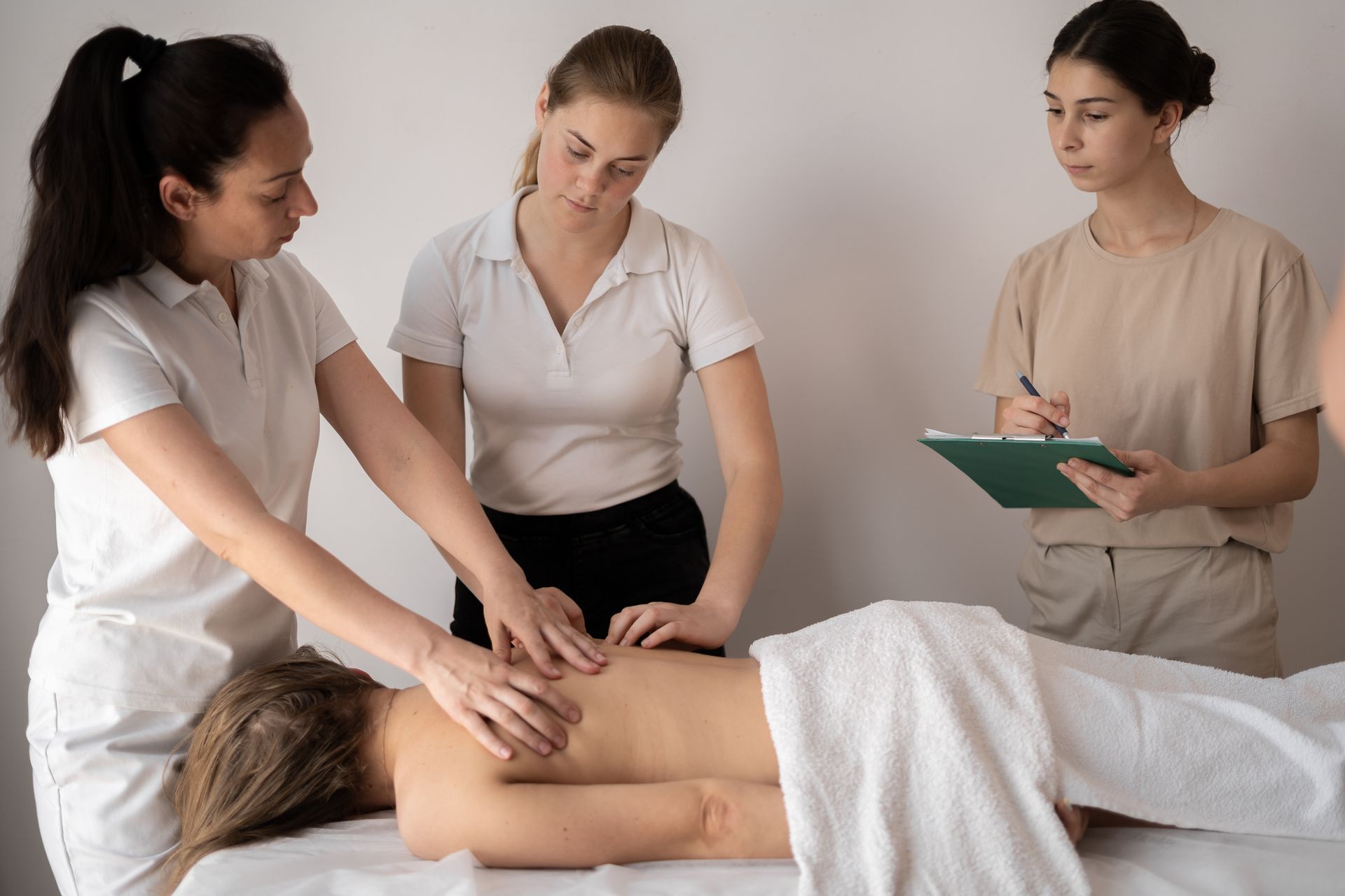 A group of women are giving a massage to a woman.