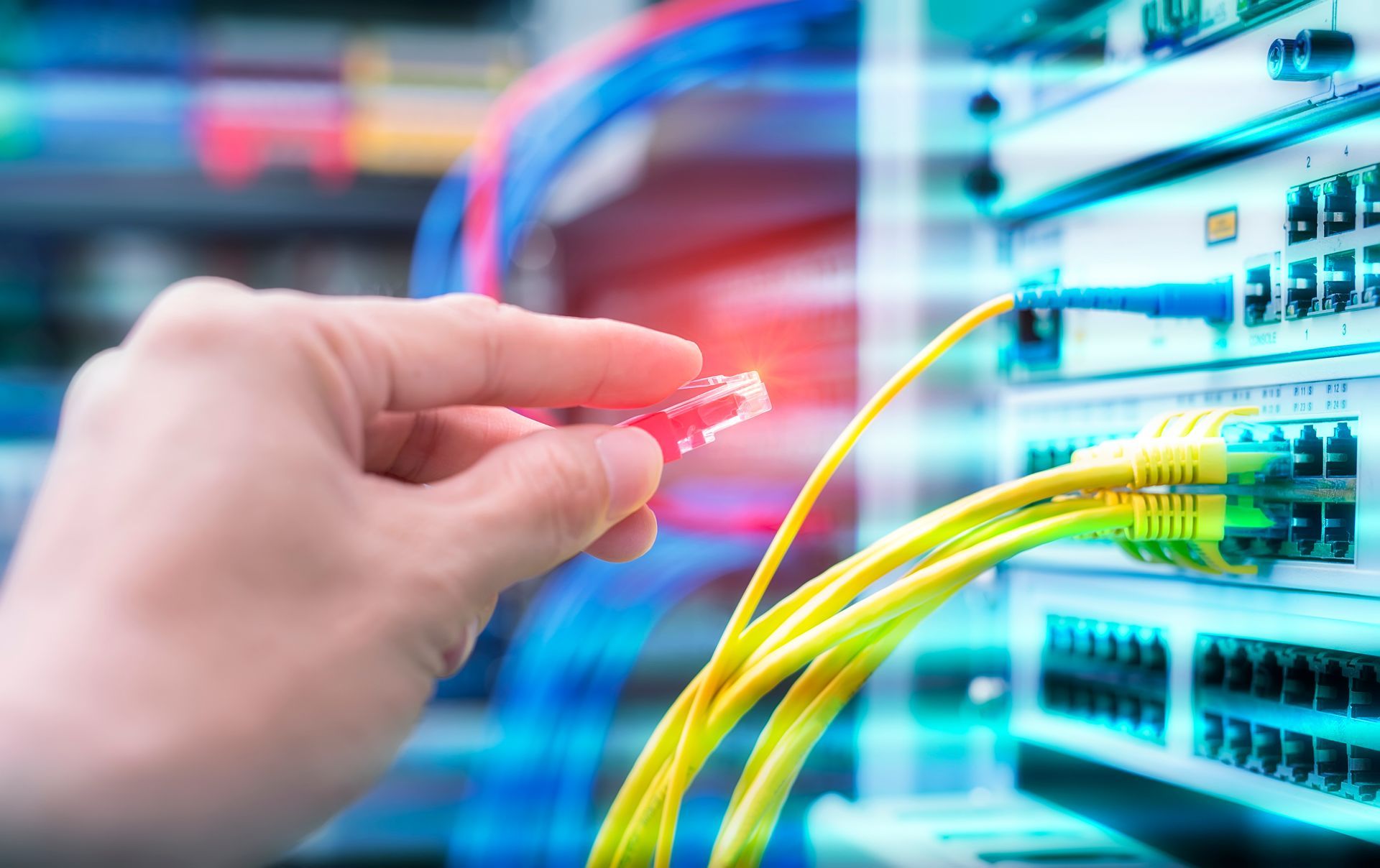 Hand Plugging a Red Ethernet Cable — Level Electrical & Air In Taminda, NSW