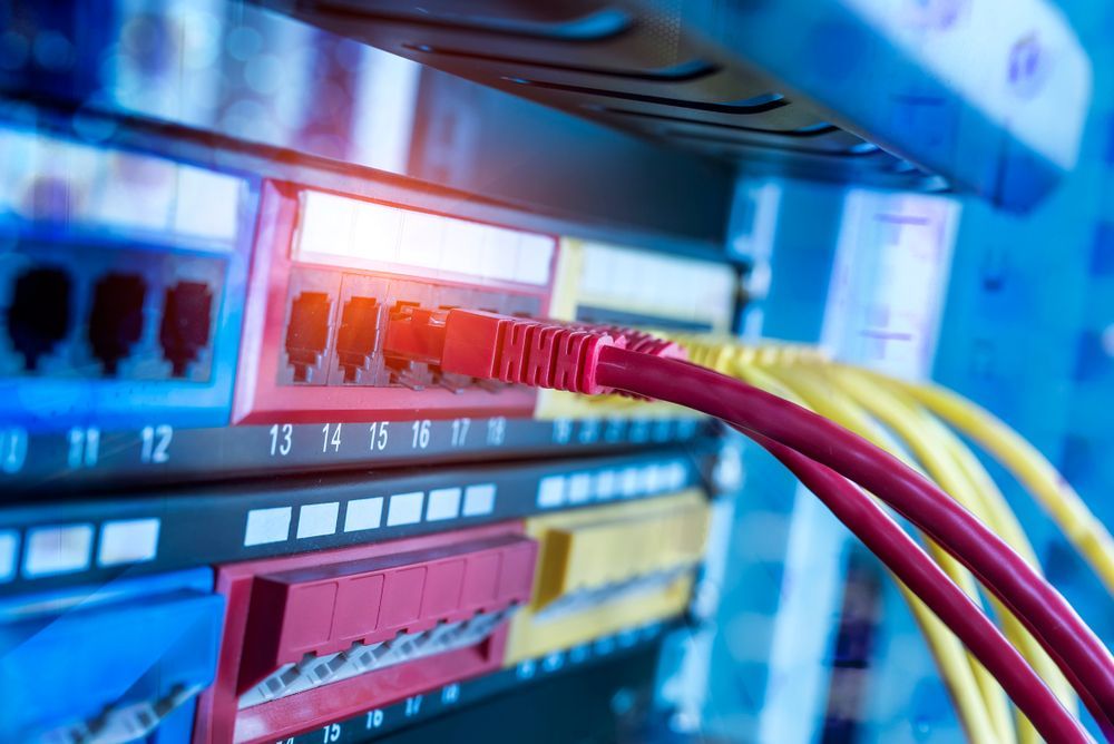 Red and Yellow Network Cables Plugged Into a Server — Level Electrical & Air In Taminda, NSW