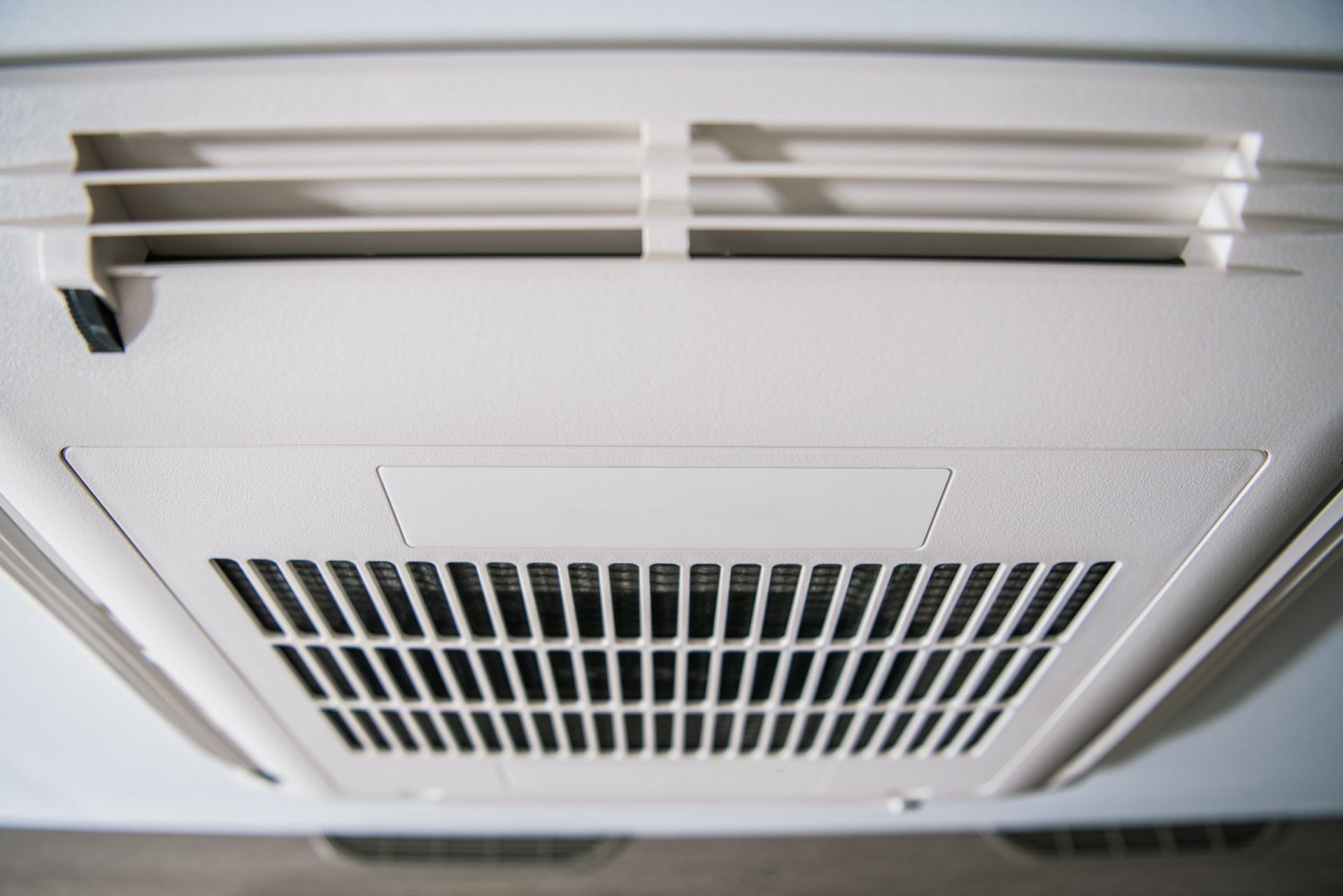 White Ceiling-mounted Air Vent With Rectangular Grille and Horizontal Slats — Level Electrical & Air In Taminda, NSW