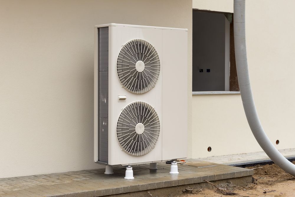 White Heat Pump Unit Mounted on Exterior Wall — Level Electrical & Air In Inverell, NSW