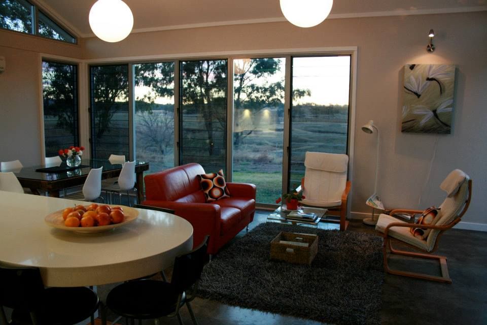 Living Room With Red Sofa, White Chairs — Level Electrical & Air In Taminda, NSW