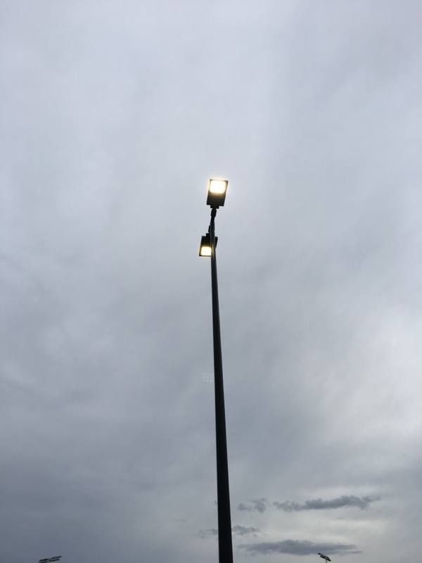 Tall Streetlight With Two Lamps Glows Against a Cloudy, Gray Sky — Level Electrical & Air In Taminda, NSW