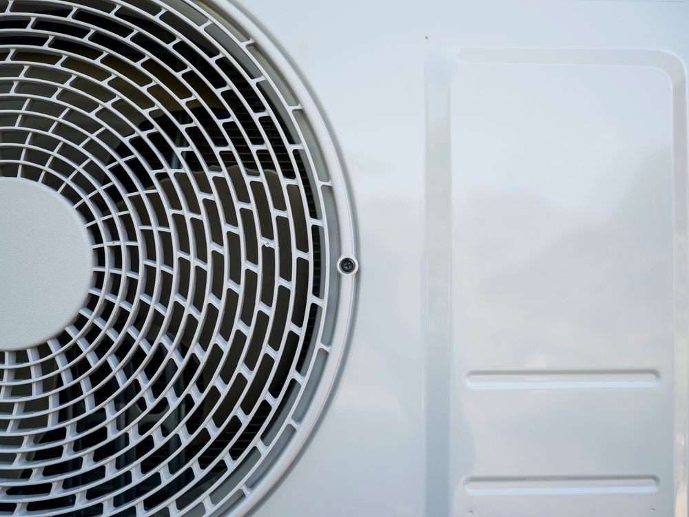 Close-up of a Circular Fan Grille Next to a White Rectangular Panel — Level Electrical & Air In Inverell, NSW