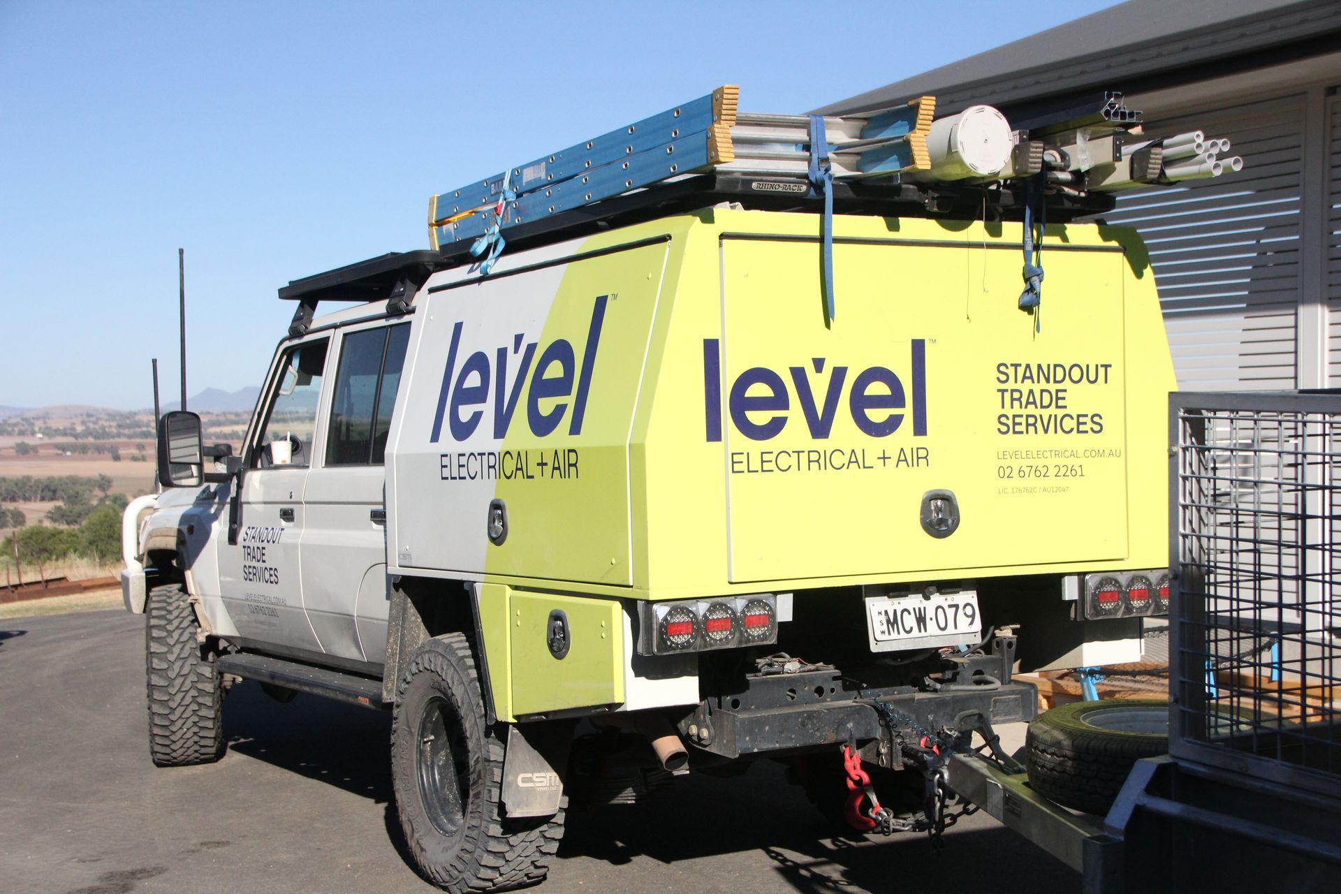 White and lime-green Level utility truck parked outdoors with roof equipment and rear-mounted gear  — Level Electrical & Air In Taminda, NSW