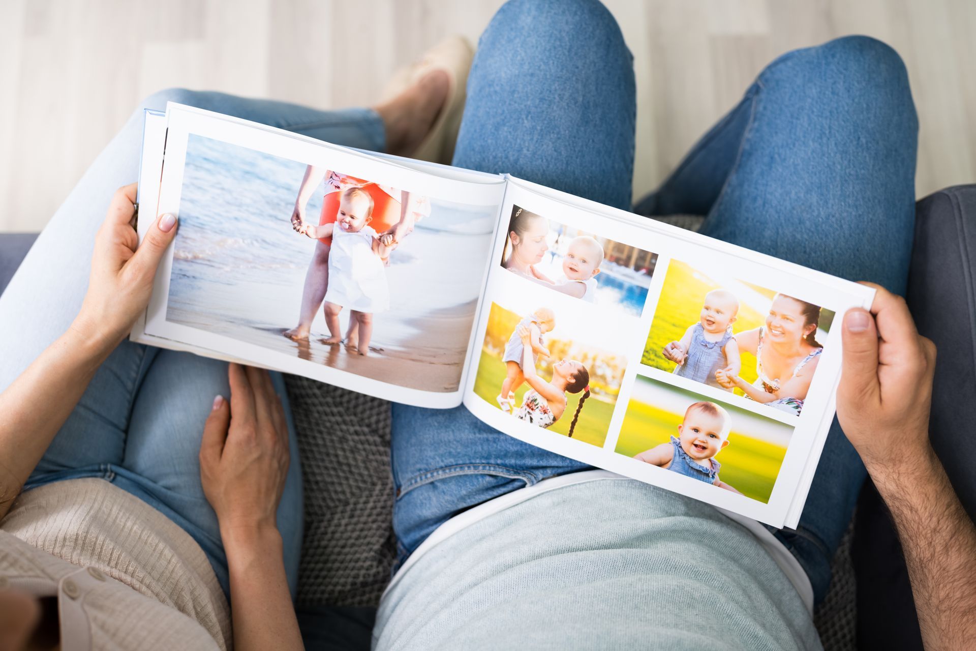 Hands holding an open magazine with colorful fashion and lifestyle photos while reclining on a couch