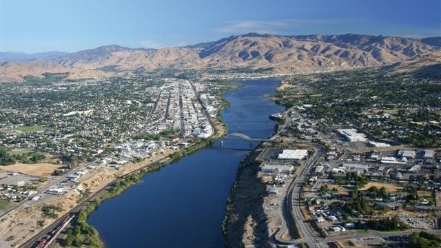 An aerial view of a river with mountains in the background