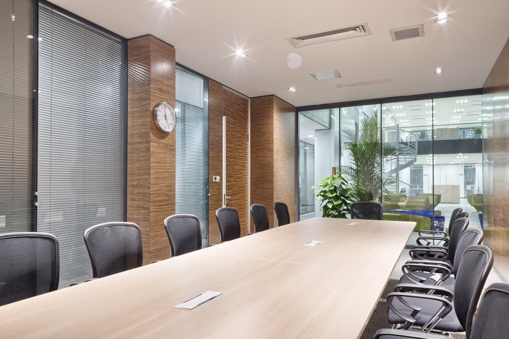 A Conference Room With a Long Table and Chairs and a Clock on the Wall — Jendata In Garbutt, QLD