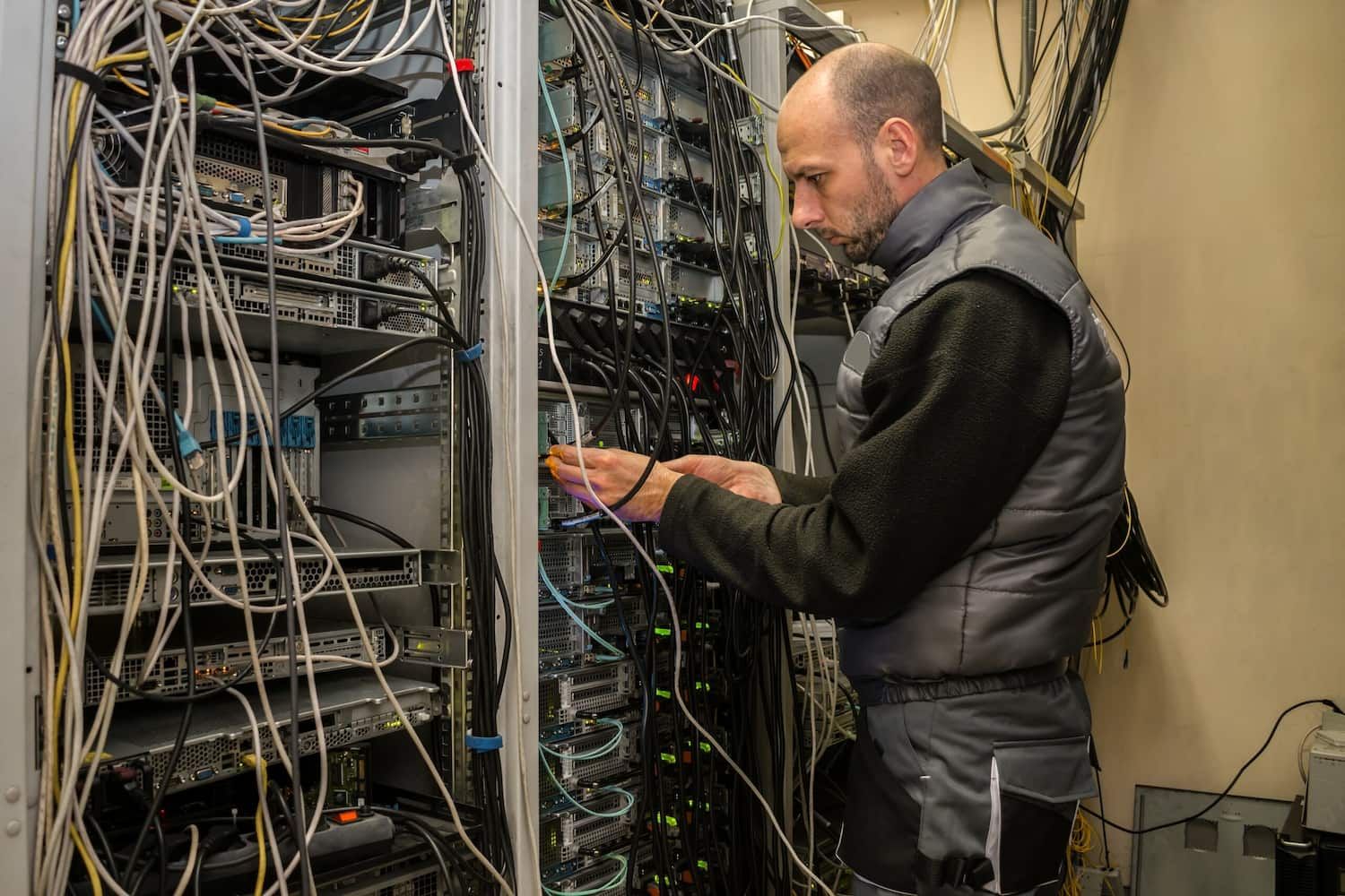 A Man is Working on a Server in a Server Room — Jendata In Garbutt, QLD