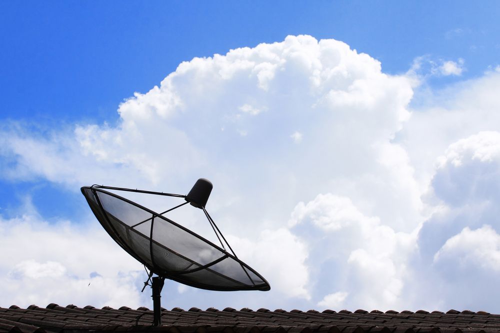 Satellite dish on rooftop against blue sky and fluffy white clouds — Jendata In Garbutt, QLD