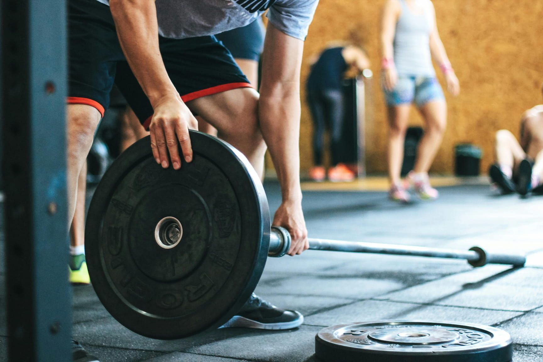 A man and a woman are talking to each other in a gym.