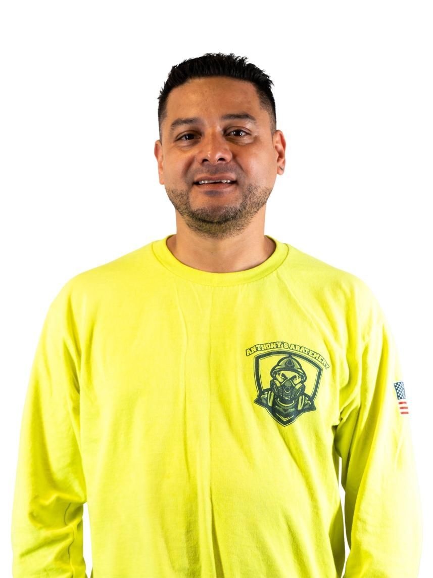 Man in a bright yellow shirt standing against a white background.