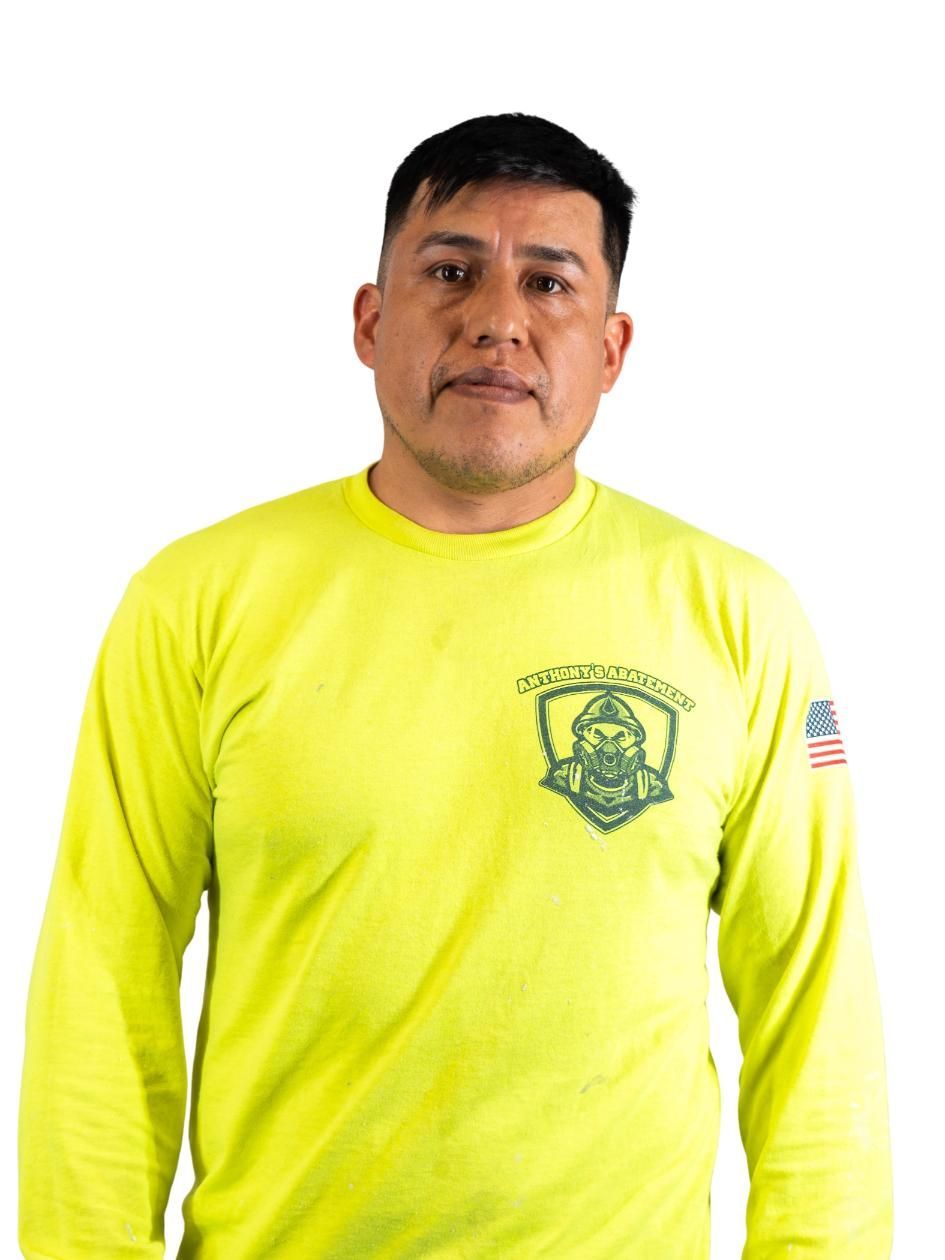 Person in a bright yellow long-sleeve shirt standing against a white background.