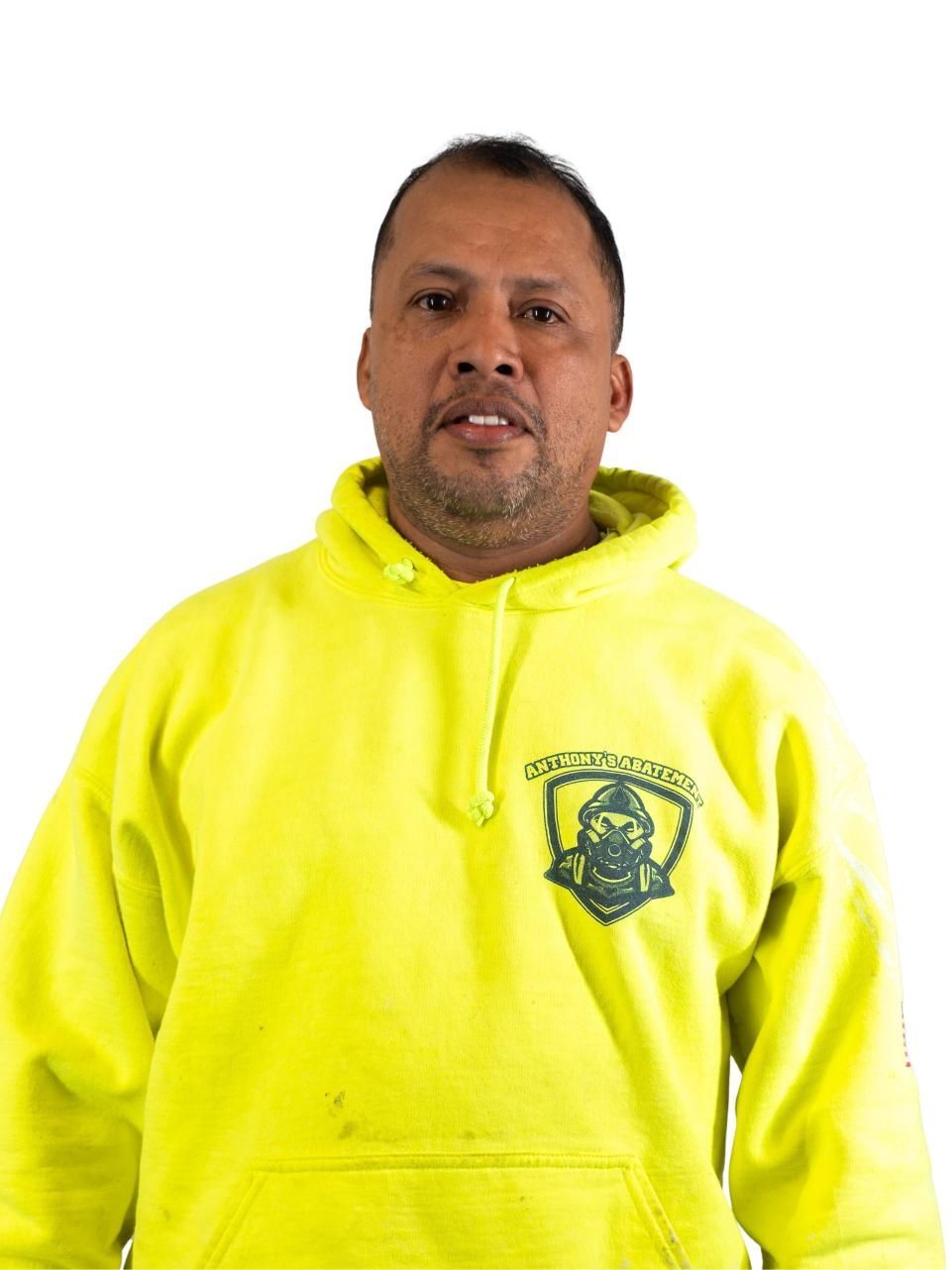 Person in a bright yellow hoodie against a white background, facing forward.