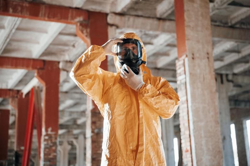 Asbestos removal worker in protective gear