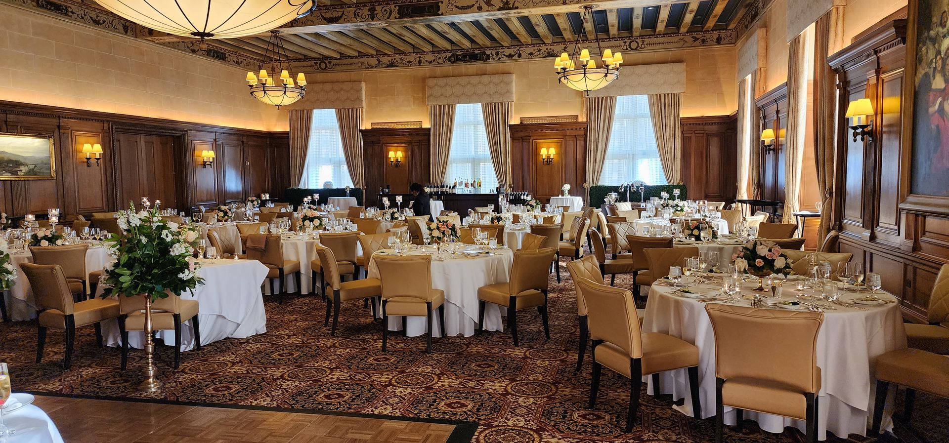A large room with tables and chairs set up for a banquet.