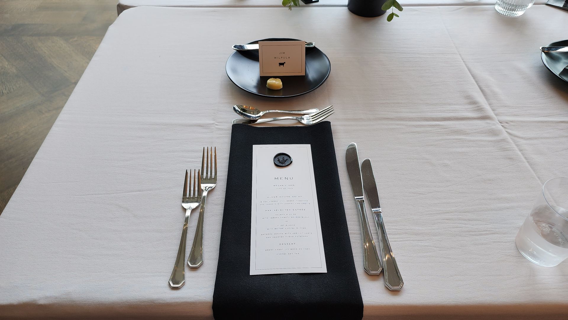 A table with silverware and a menu on it
