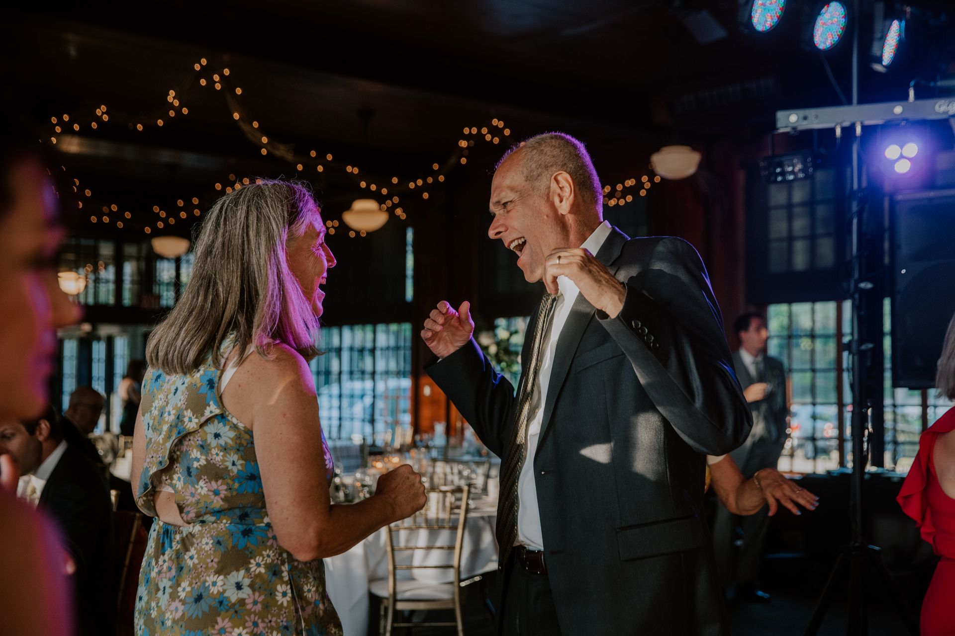 A man and a woman are dancing together at a wedding reception.