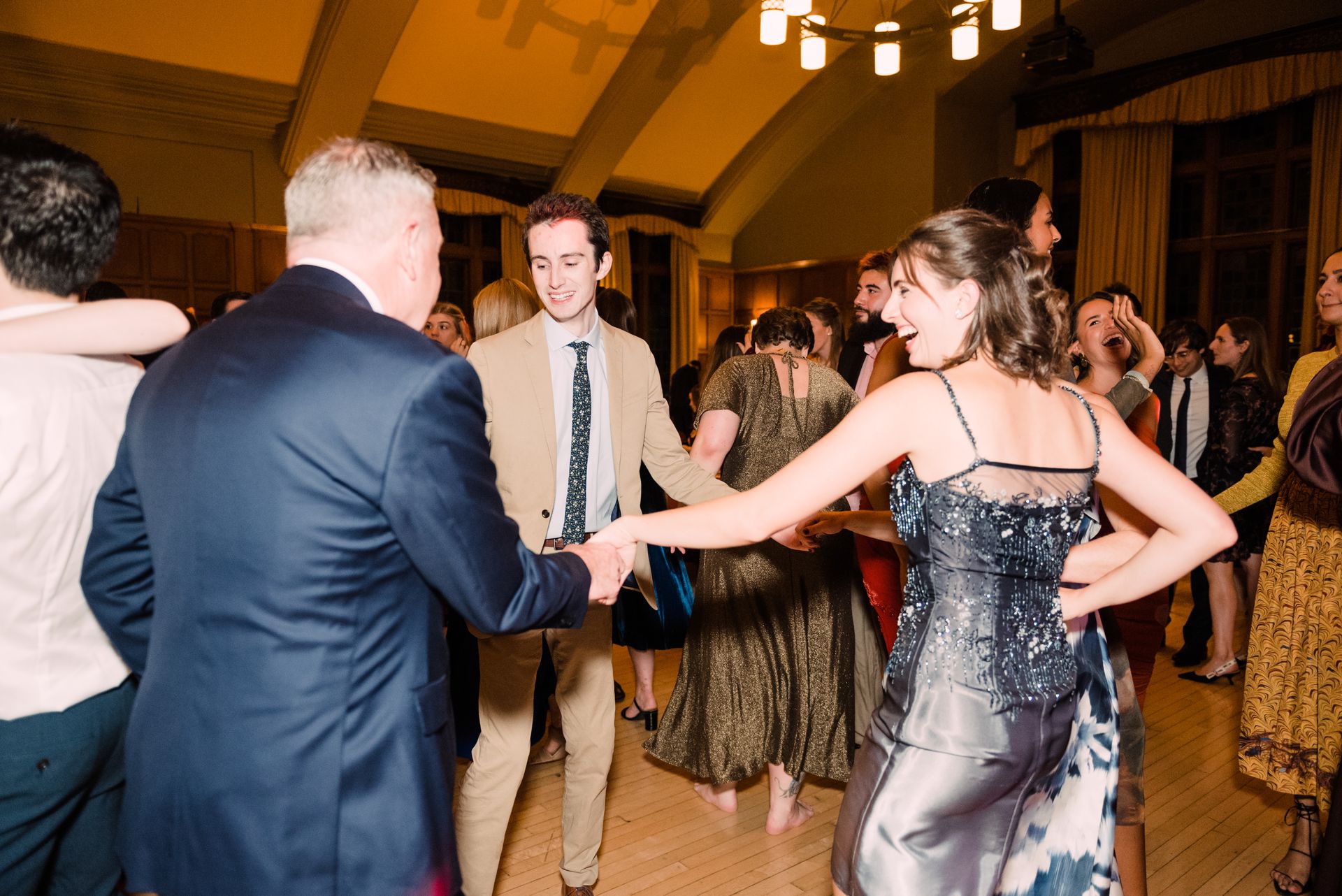 A group of people are dancing together in a room