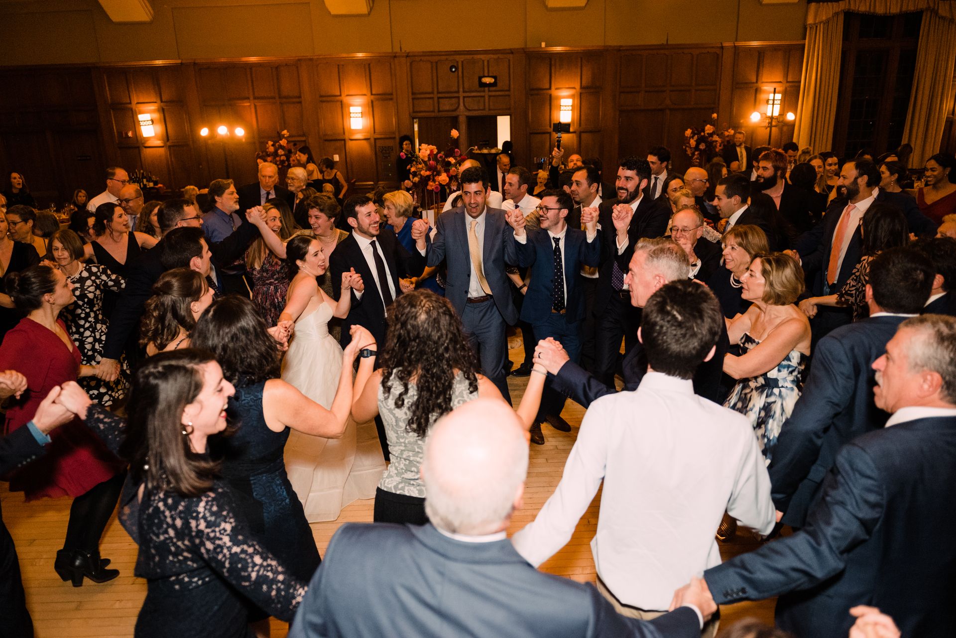A large group of people are dancing in a room.