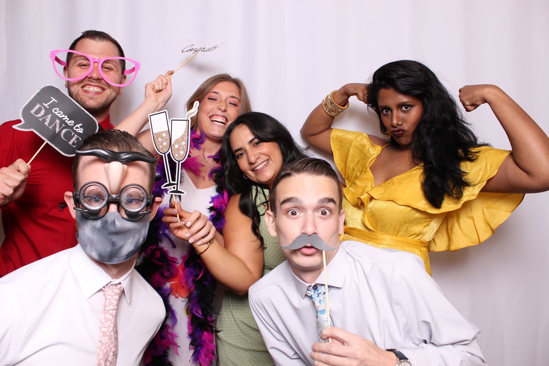 a group of people posing with Ever After Photo Booth Co. in Detroit, MI with a prop sign that says I came to dance